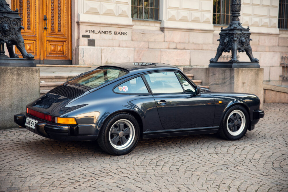 Vintage Porsche car parked near historic building