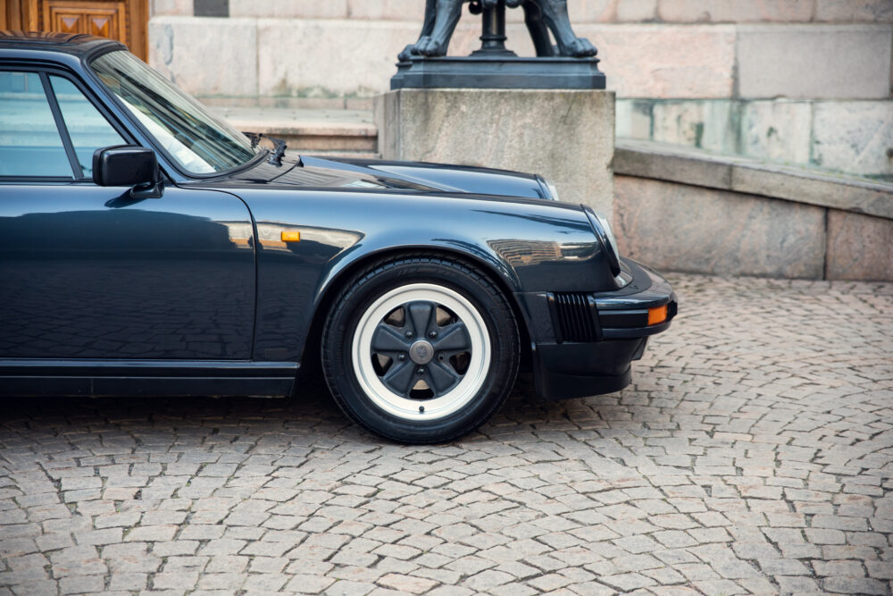 Vintage black sports car on cobblestone street