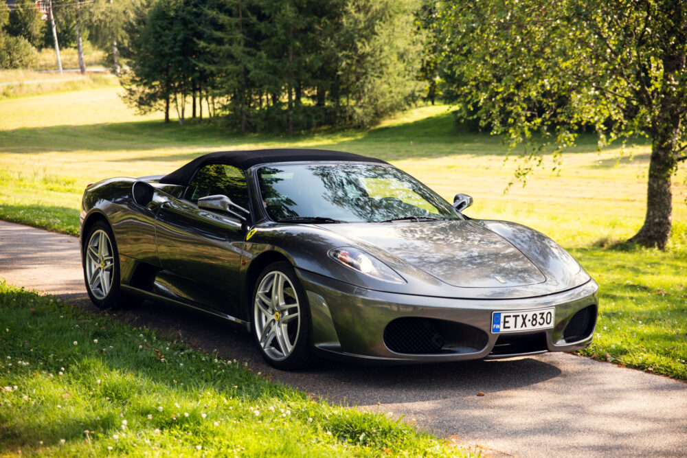Silver convertible sports car parked in green countryside
