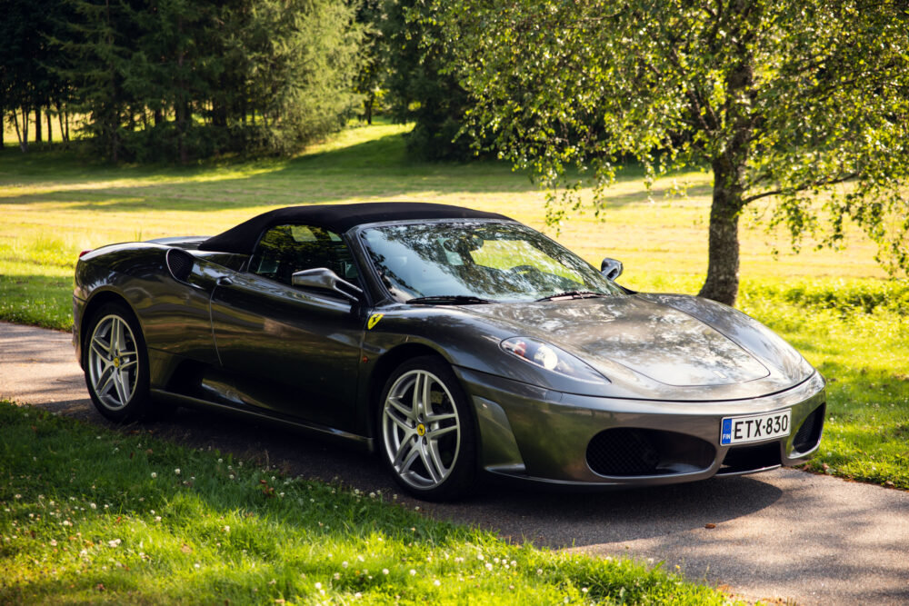 Black convertible sports car parked in a sunny park