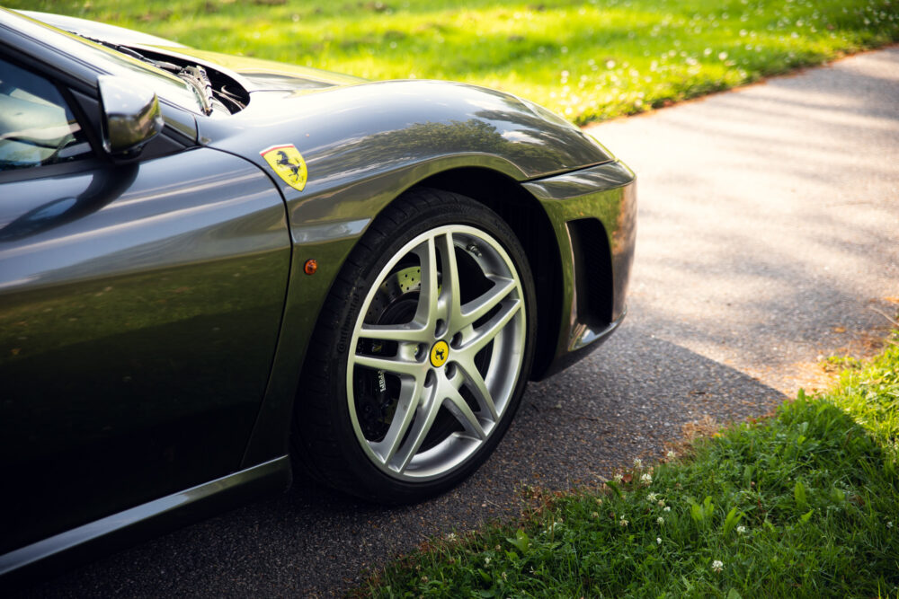 Green Ferrari car parked on roadside