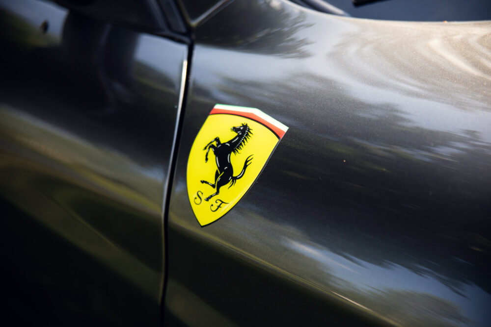 Ferrari logo on sleek black car surface