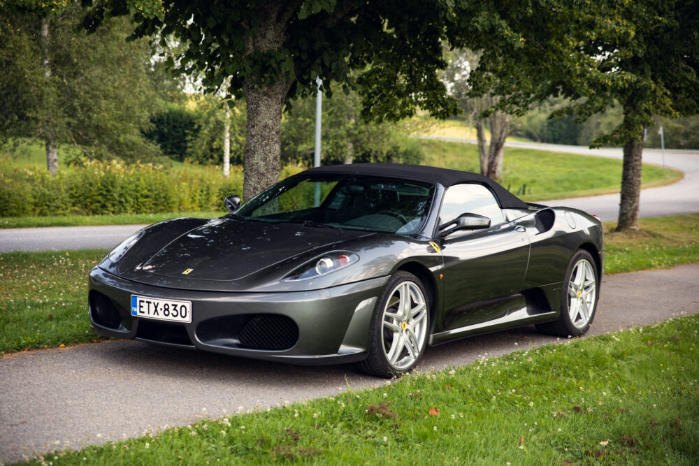 Gray convertible sports car parked beside road