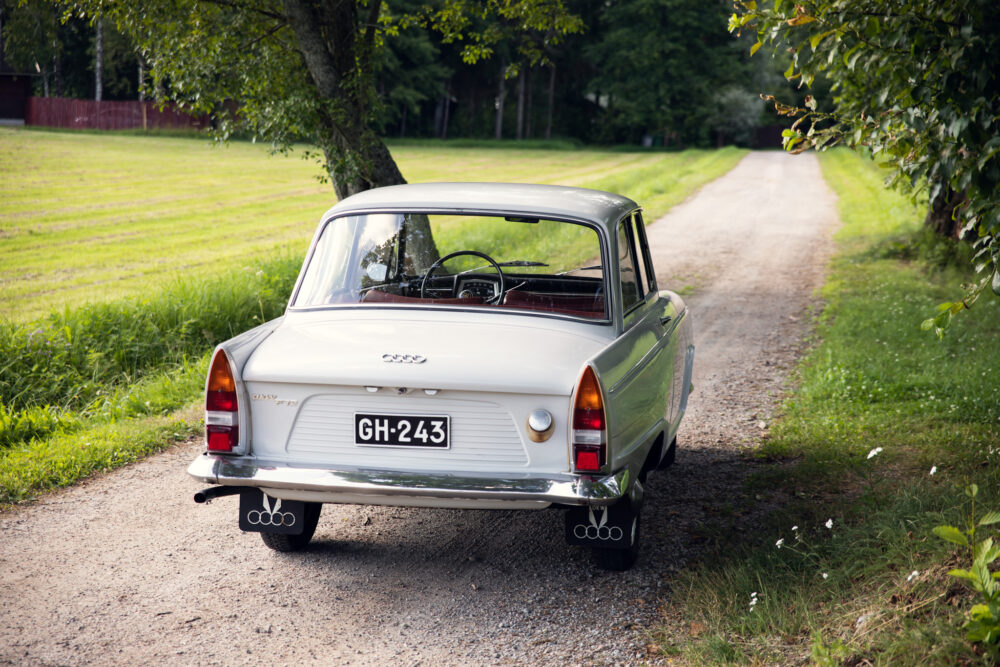 Vintage white car parked on rural dirt road