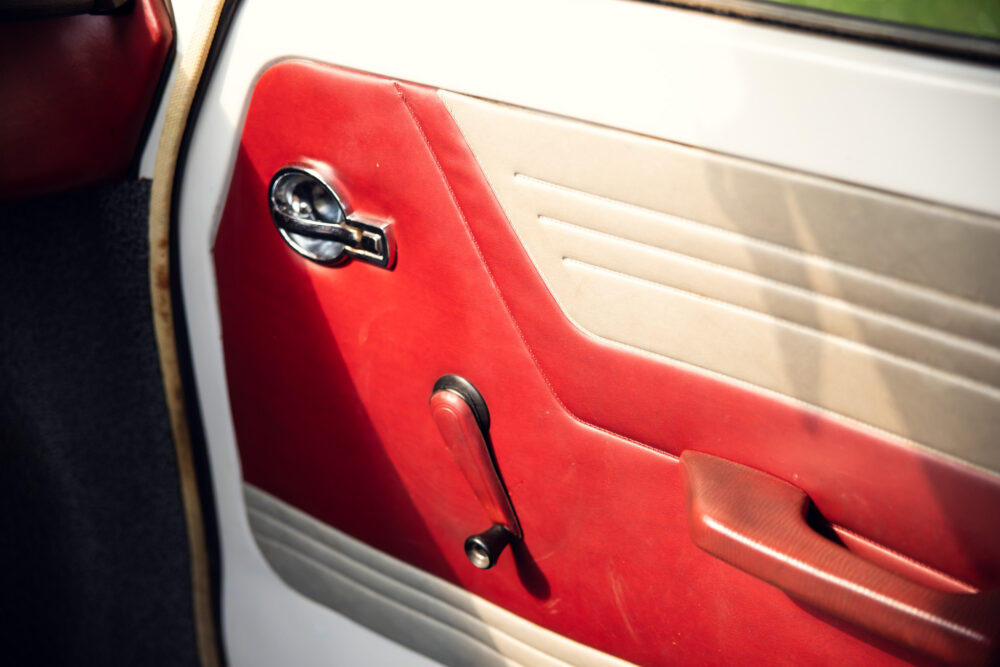 Vintage red car door interior with chrome handle