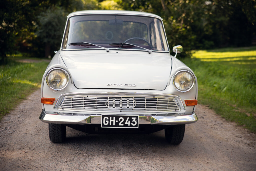 Vintage white Audi on forest road