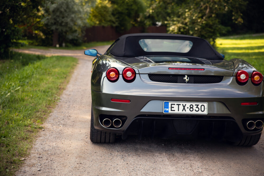 Silver convertible sports car on a rural path
