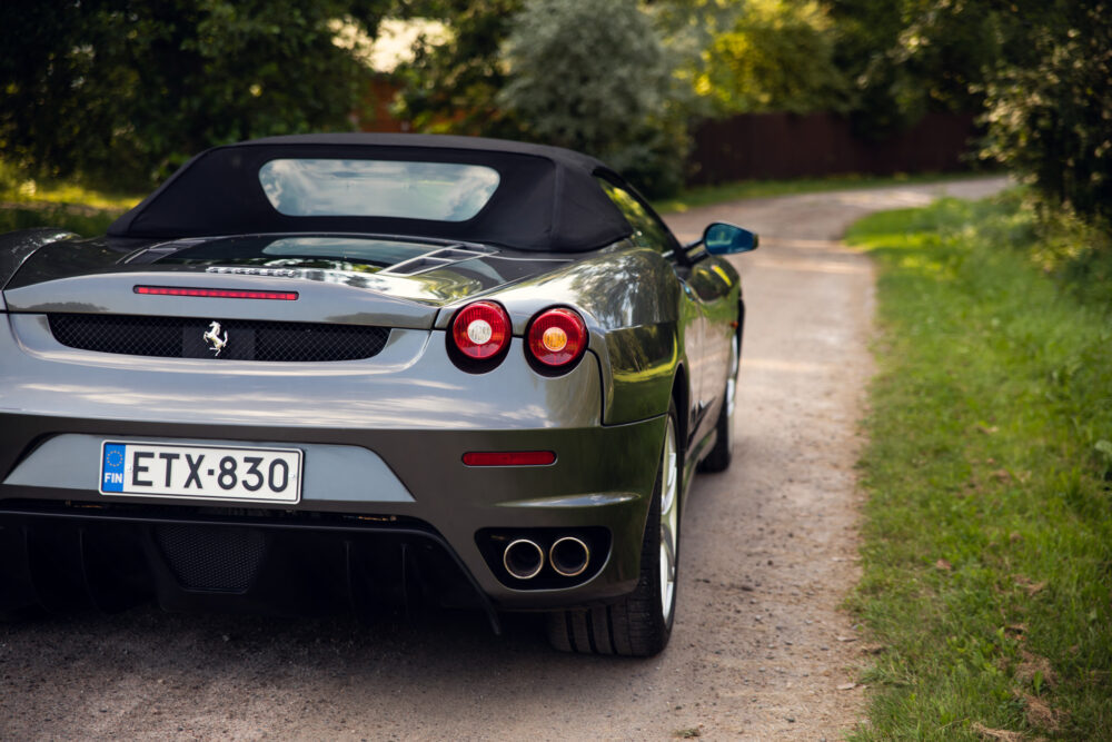 Silver convertible Ferrari parked on rural road