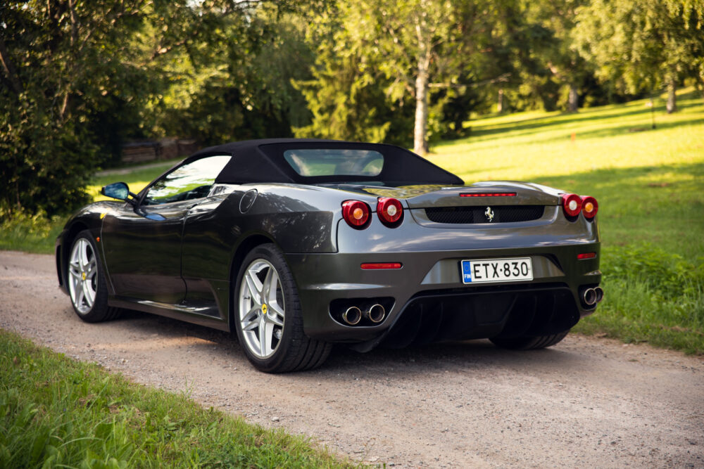 Gray convertible Ferrari parked on a scenic country road