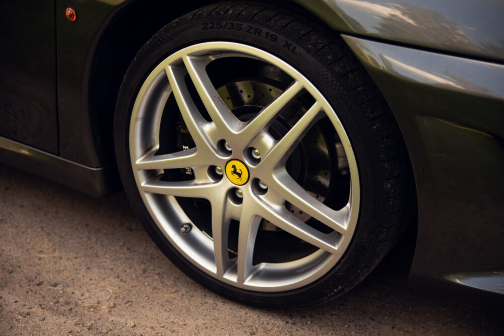 Close-up of sports car wheel with logo