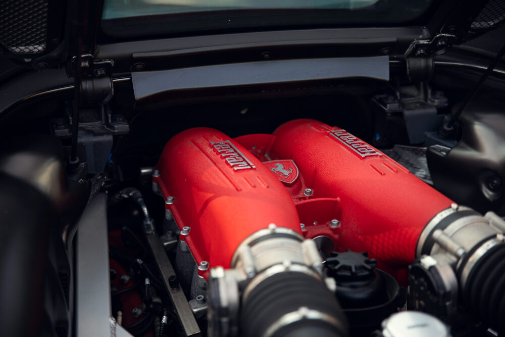 Red Ferrari engine close-up in car