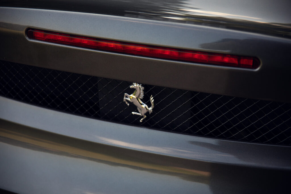 Close-up of sports car's rear emblem and grille
