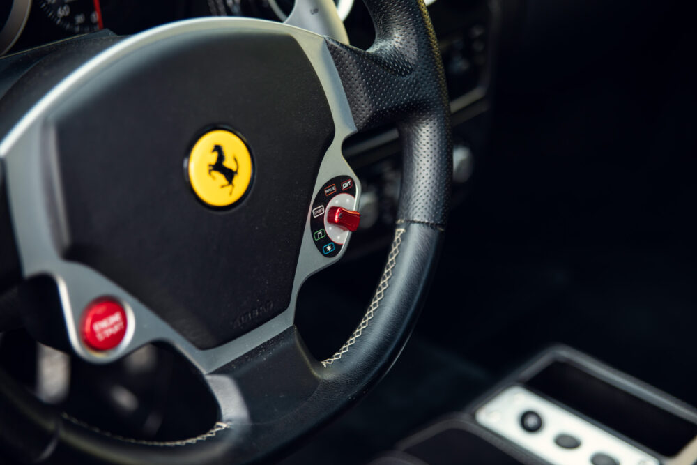Close-up of Ferrari steering wheel with logo