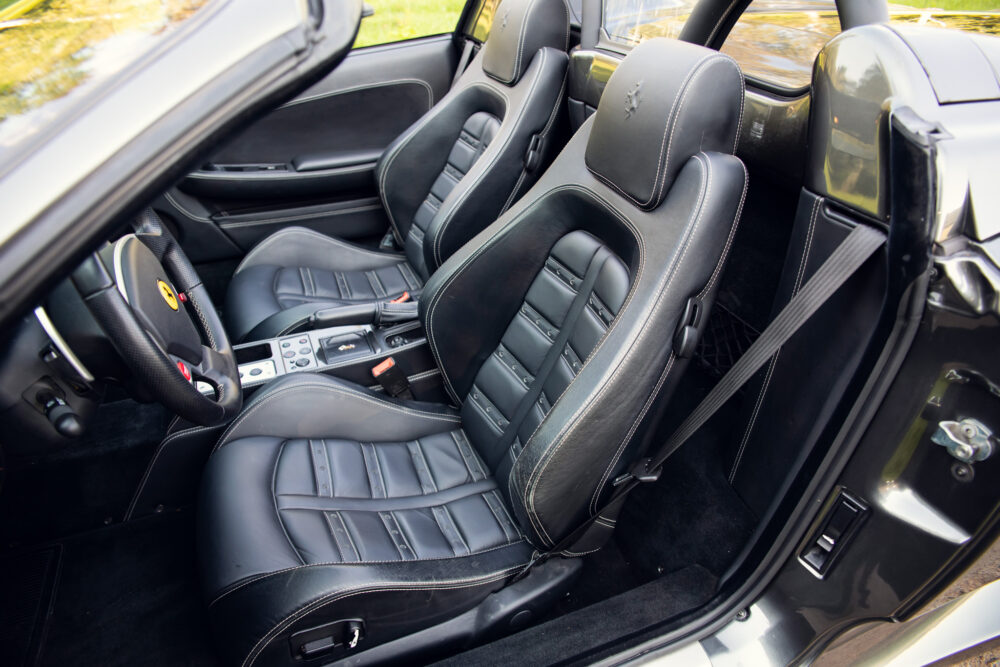 Luxury car interior with black leather seats and controls