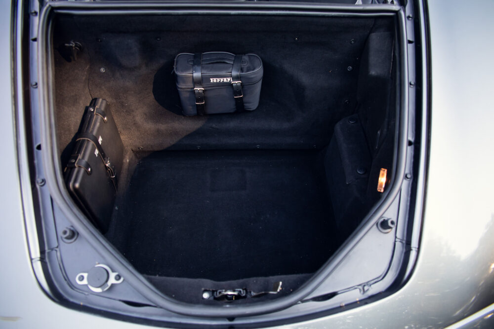 Open car trunk with two leather bags inside
