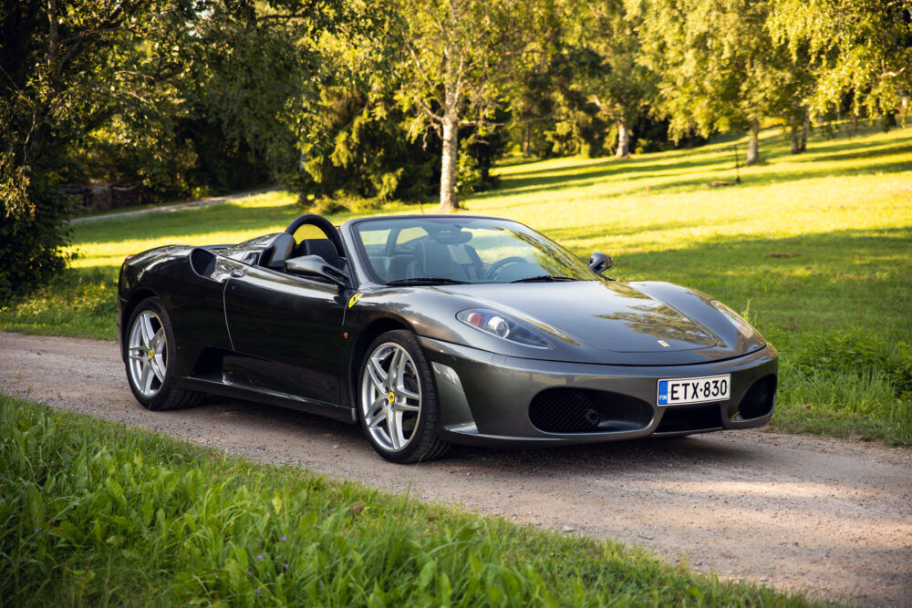 Black convertible sports car parked in green park