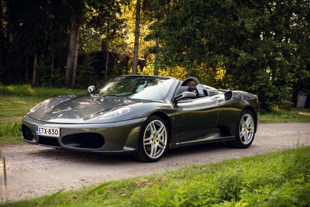 Silver convertible sports car parked in wooded area