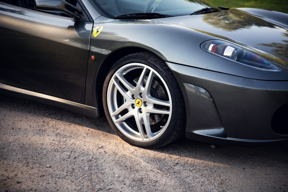 Close-up of Ferrari wheel and sleek gray car body