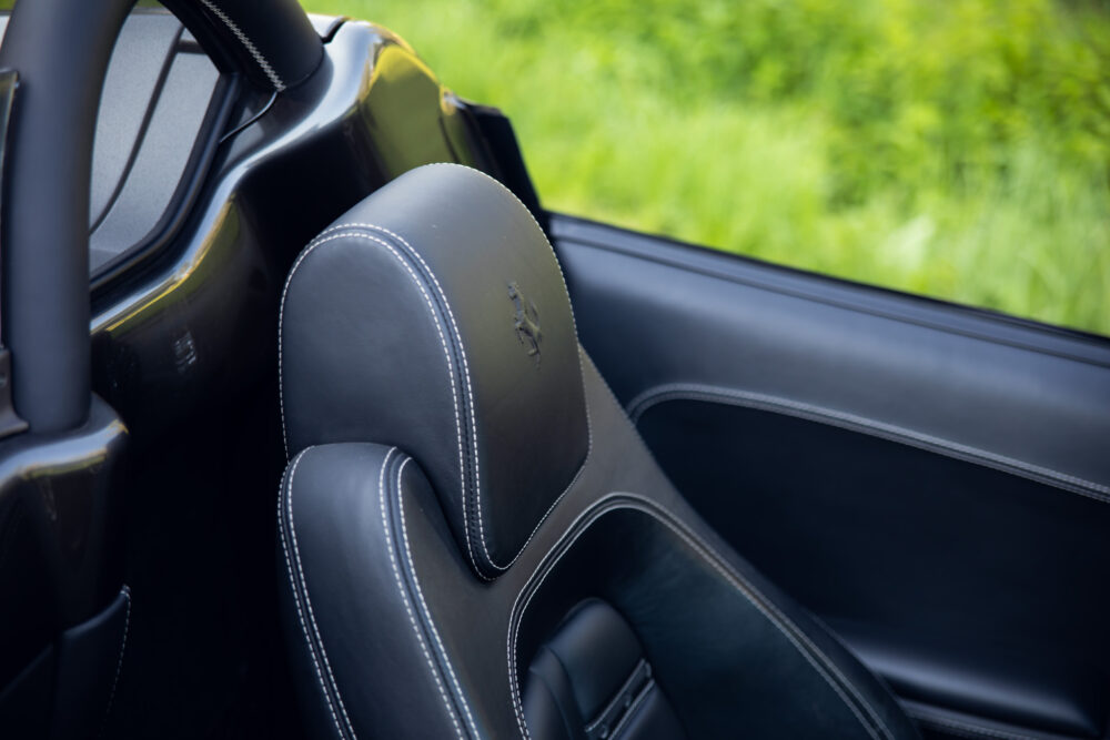 Close-up of black luxury car seat with logo