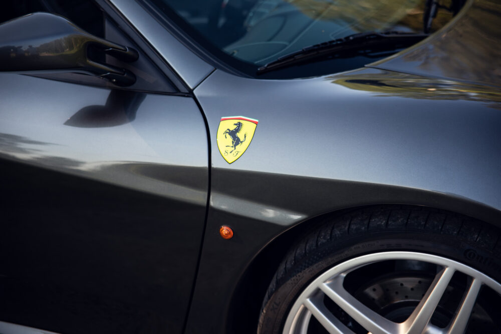 Luxury car logo on shiny silver vehicle door