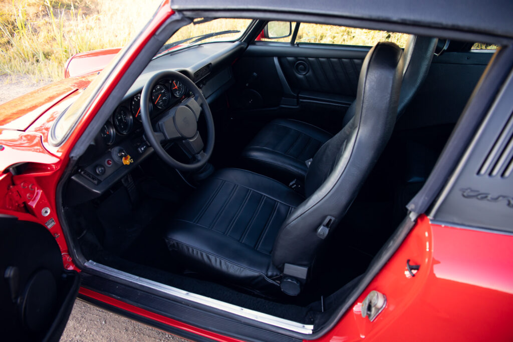 Red vintage car interior with black leather seats