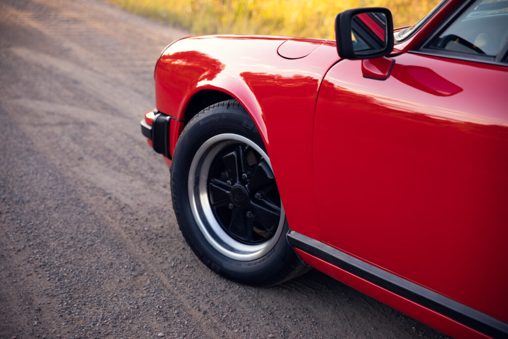 Red vintage sports car on a gravel road