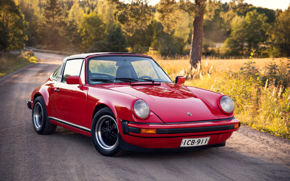 Red vintage Porsche on scenic rural road