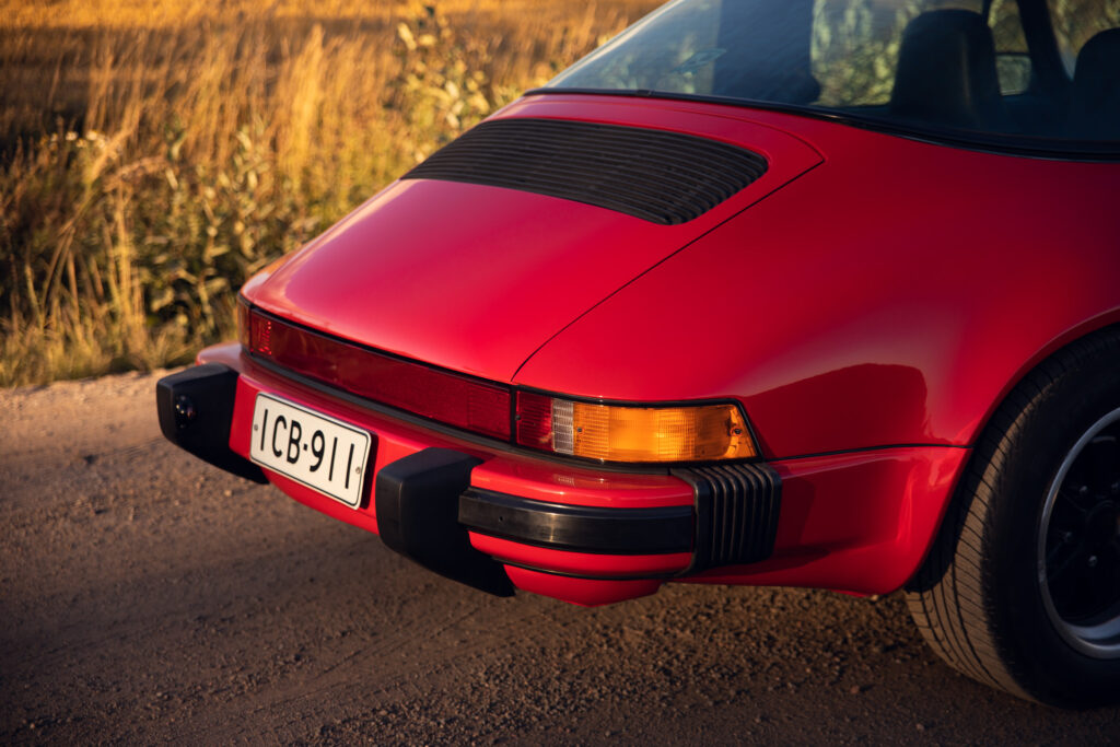 Red vintage sports car rear view at sunset