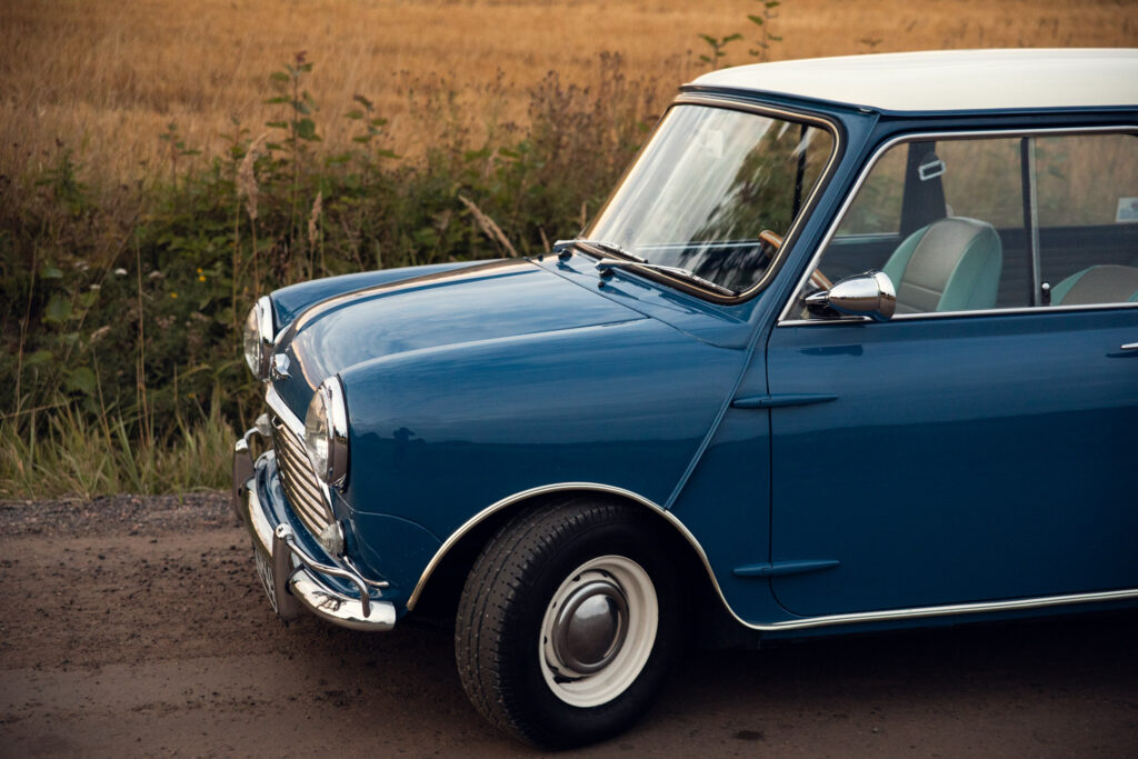 Vintage blue car parked in a rural field