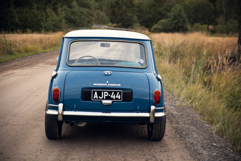 Vintage blue Morris Cooper car on rural road