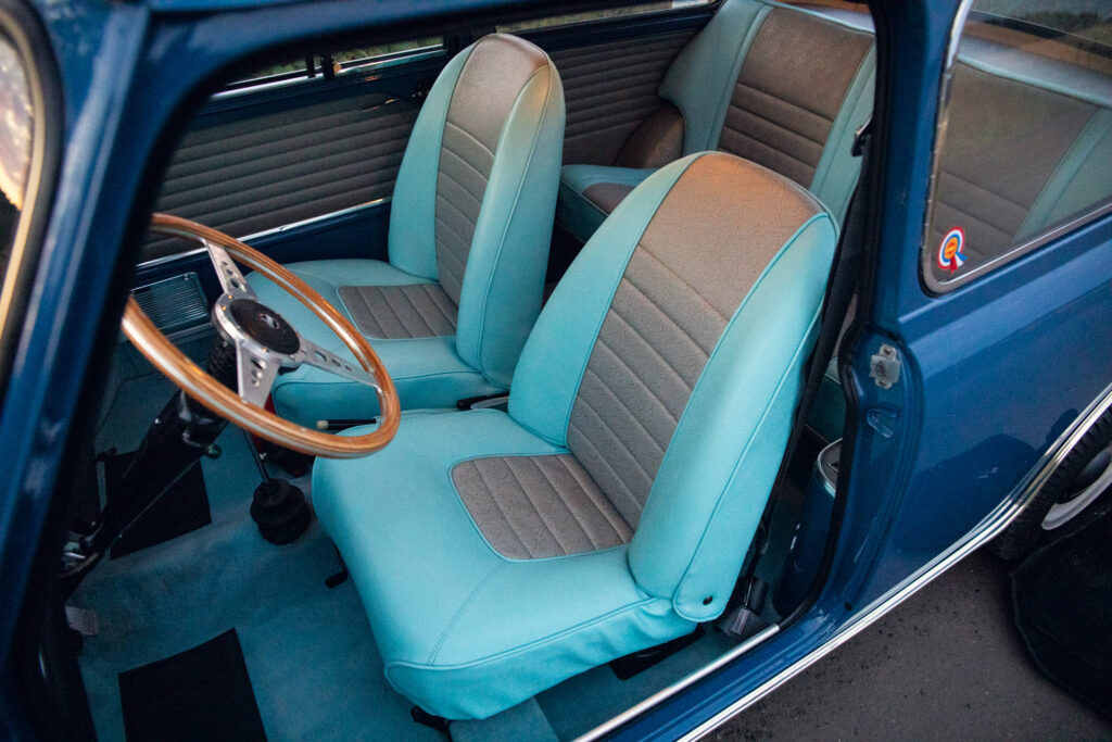 Vintage blue car interior with stylish seats and wheel