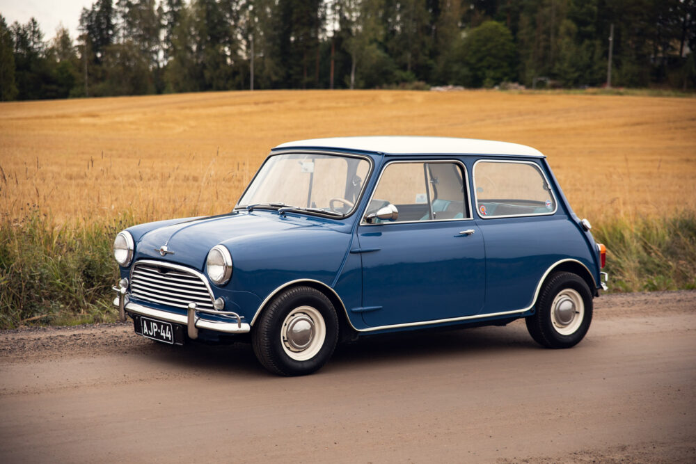 Vintage blue Mini Cooper parked in rural setting