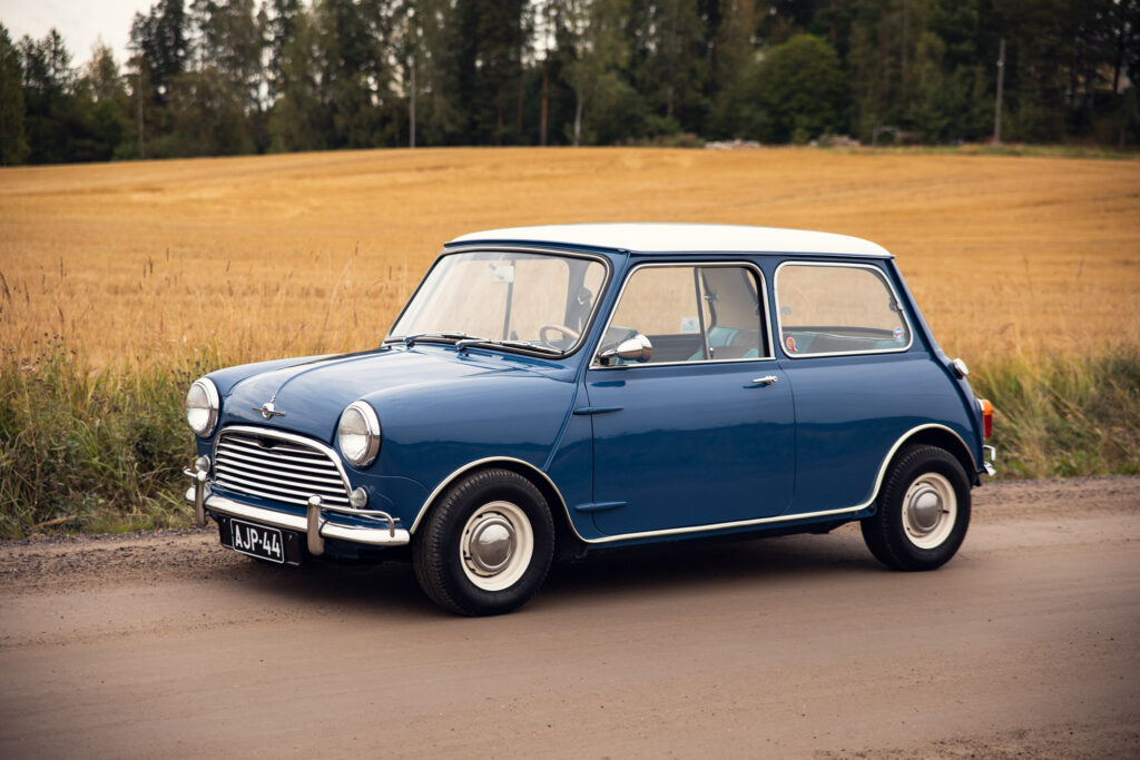 Vintage blue Mini Cooper parked in rural setting