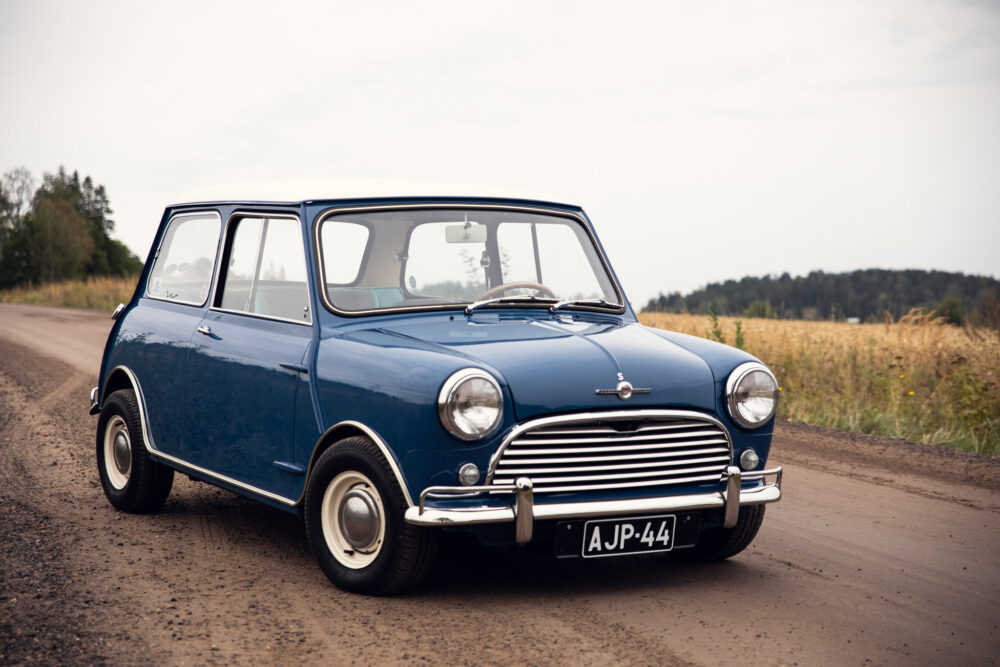 Vintage blue Mini Cooper on rural road