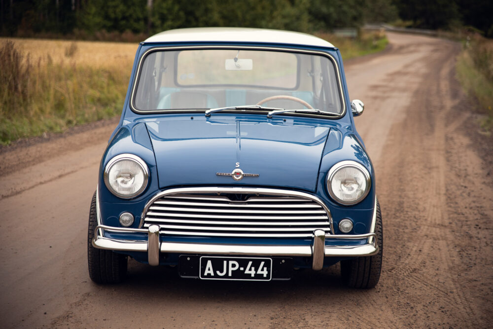 Vintage blue Mini Cooper on a country road