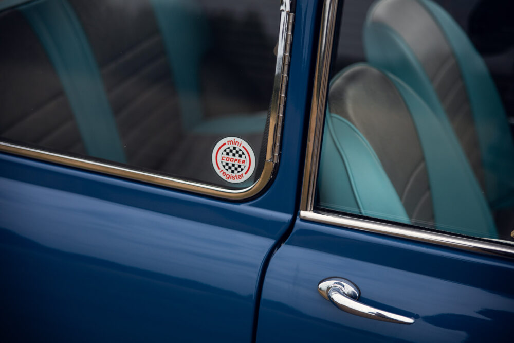 Vintage blue Mini Cooper with club sticker on window