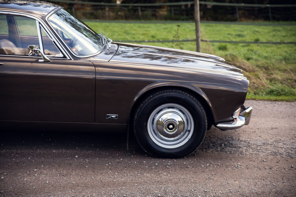 Vintage brown car parked on countryside road