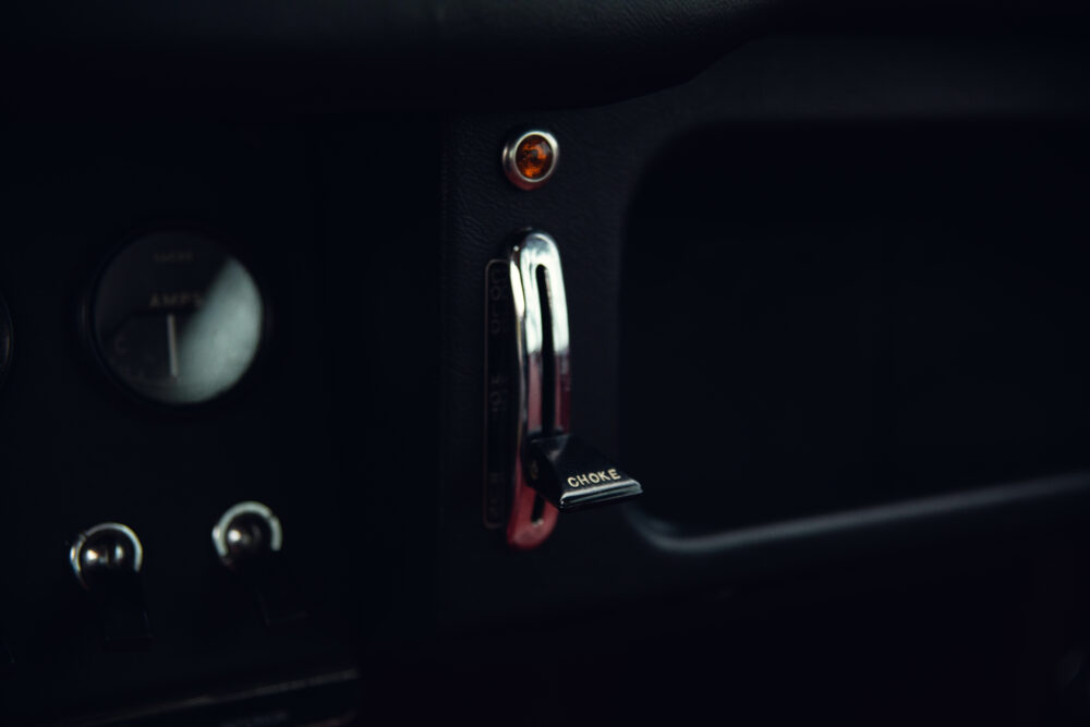 Vintage car's choke lever and dashboard close-up