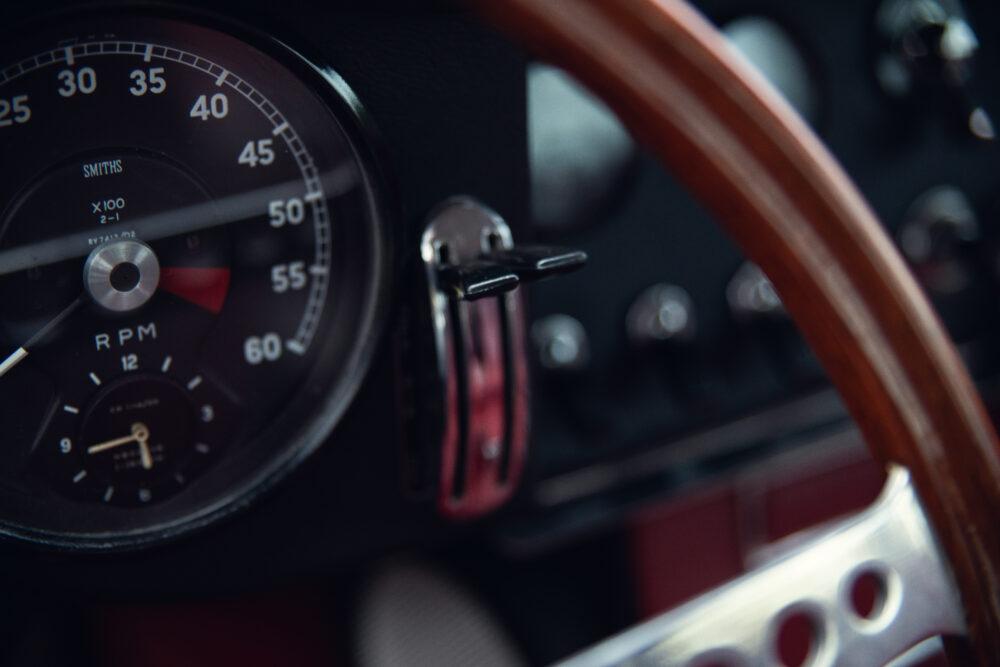 Vintage car dashboard with wooden steering wheel