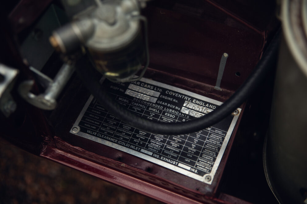 Vintage car engine detail with lubricant specifications plaque