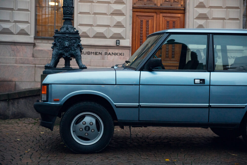 Vintage car parked near ornate lamp post