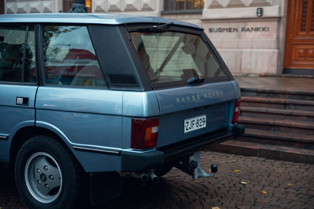 Blue Range Rover parked outside stone building