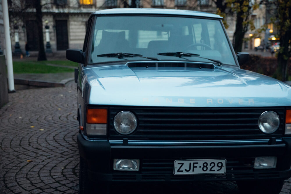 Vintage Range Rover parked on cobblestone street