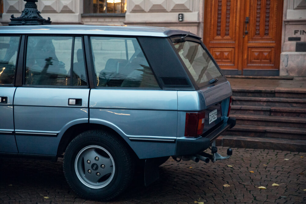 Vintage car parked near building entrance
