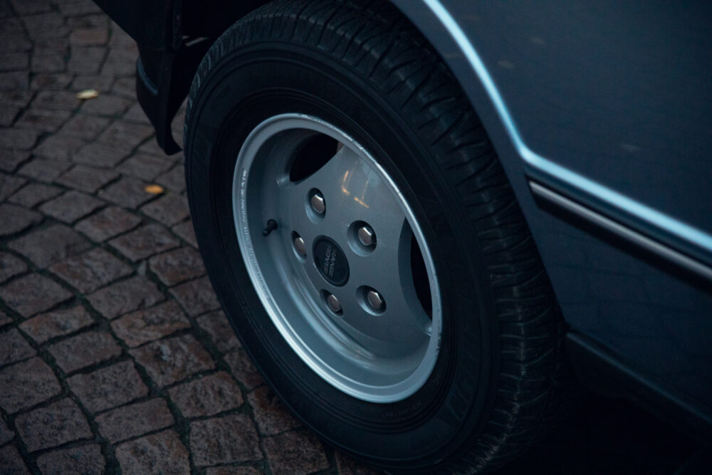 Close-up of car wheel on cobblestone street