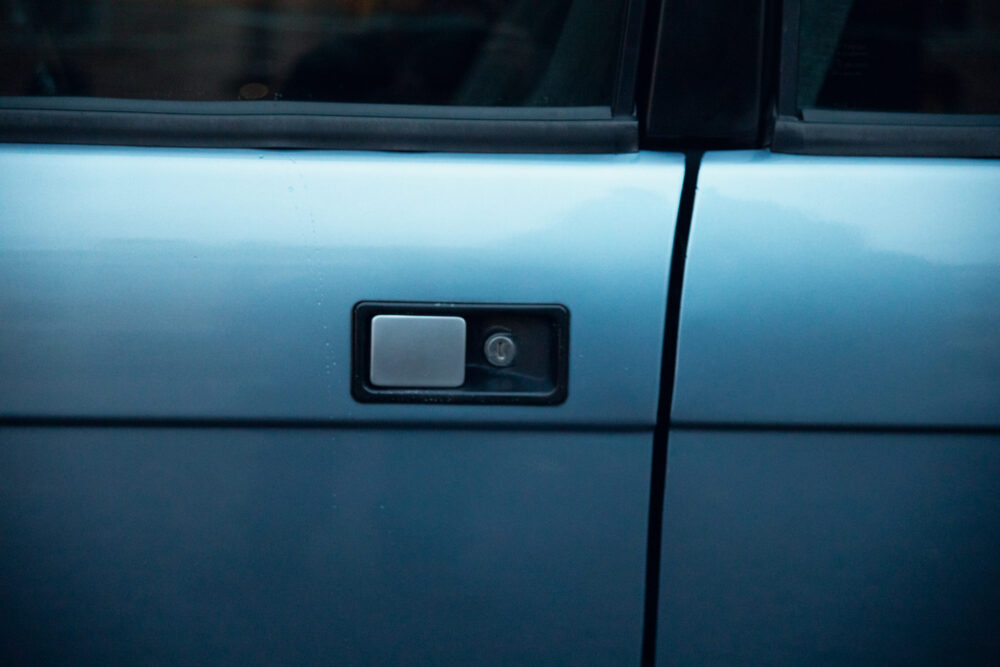Close-up of blue car's door handle