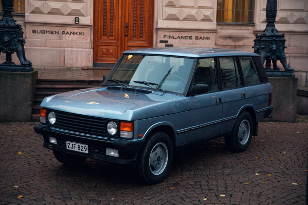 Vintage blue SUV parked outside Finland's Bank building