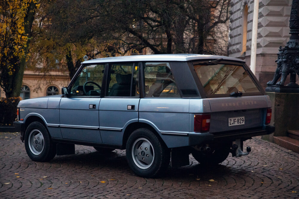 Vintage Range Rover parked on cobblestone street