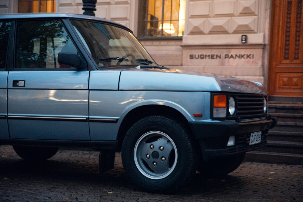 Vintage car parked in front of Suomen Pankki building