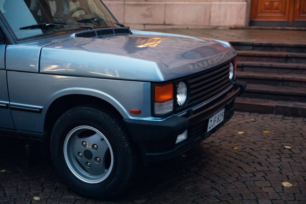 Silver Range Rover parked on cobblestone street